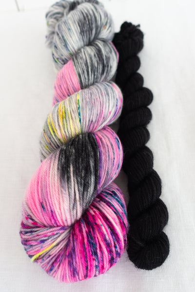 Skip Rope Yarn Co sock set - one full size skein of speckled pink, black and purple yarn with a 20 gram mini-skein in black on a white background