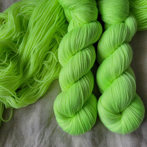 Skeins of hand dyed sock yarn in lime green