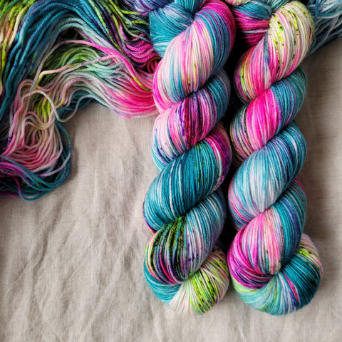 Skeins of hand dyed yarn in blue and pink