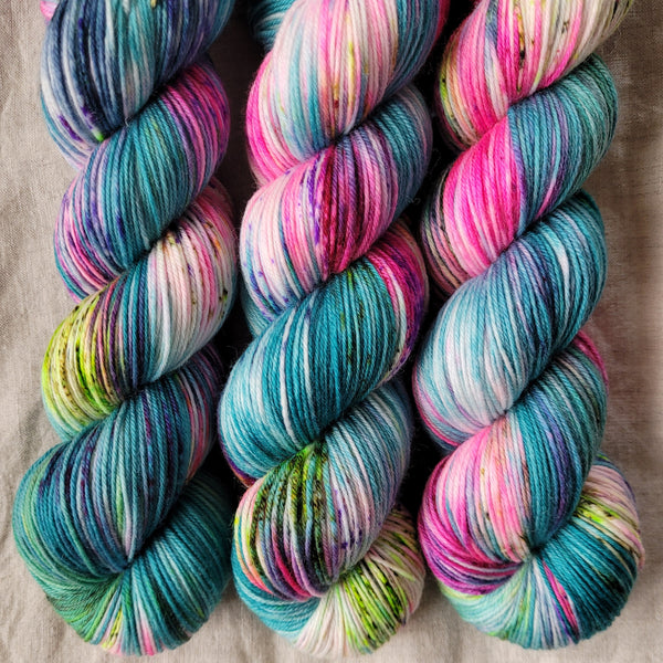 Skeins of hand dyed yarn in blue and pink